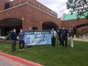 EMS Week participants in front of their sign.